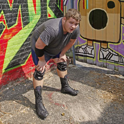 a wrestler loos exhausted at the camera